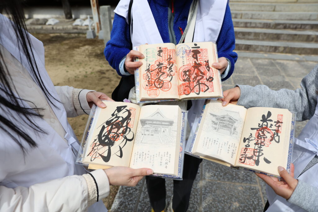 Pilgrims show off their nokyo-cho stamp books. Beyond a piece of pilgrimage gear, temple stamps serve as beautiful mementos of one's journey.