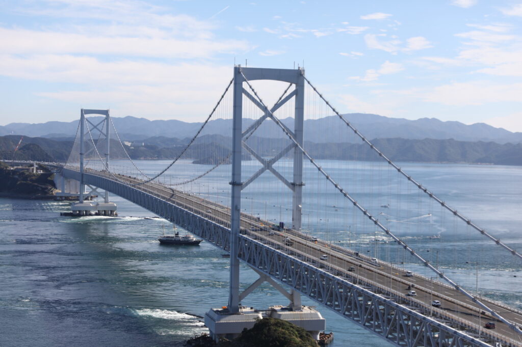 The Ohnaruto Bridge spanning across the sea with visible whirlpools.
