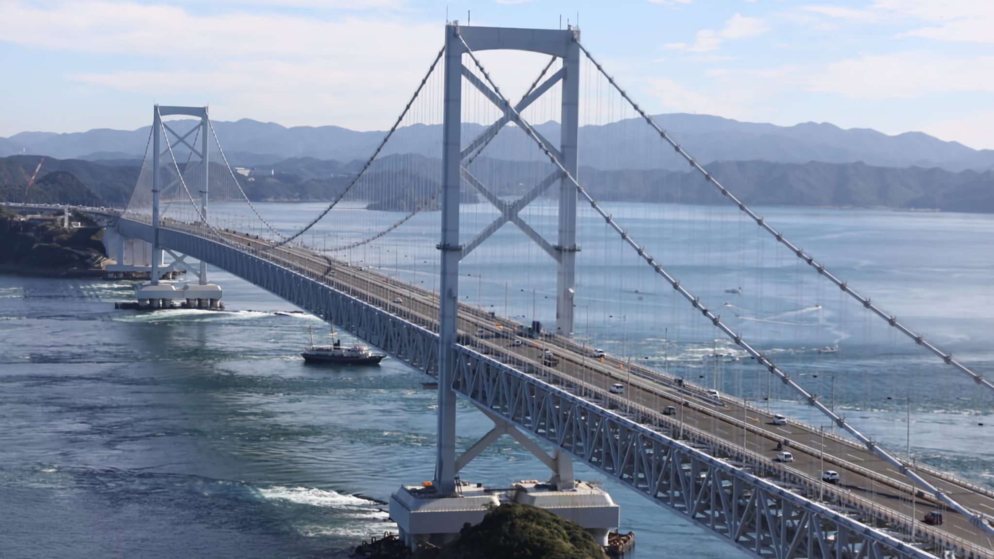 The Ohnaruto Bridge spanning across the sea with visible whirlpools.