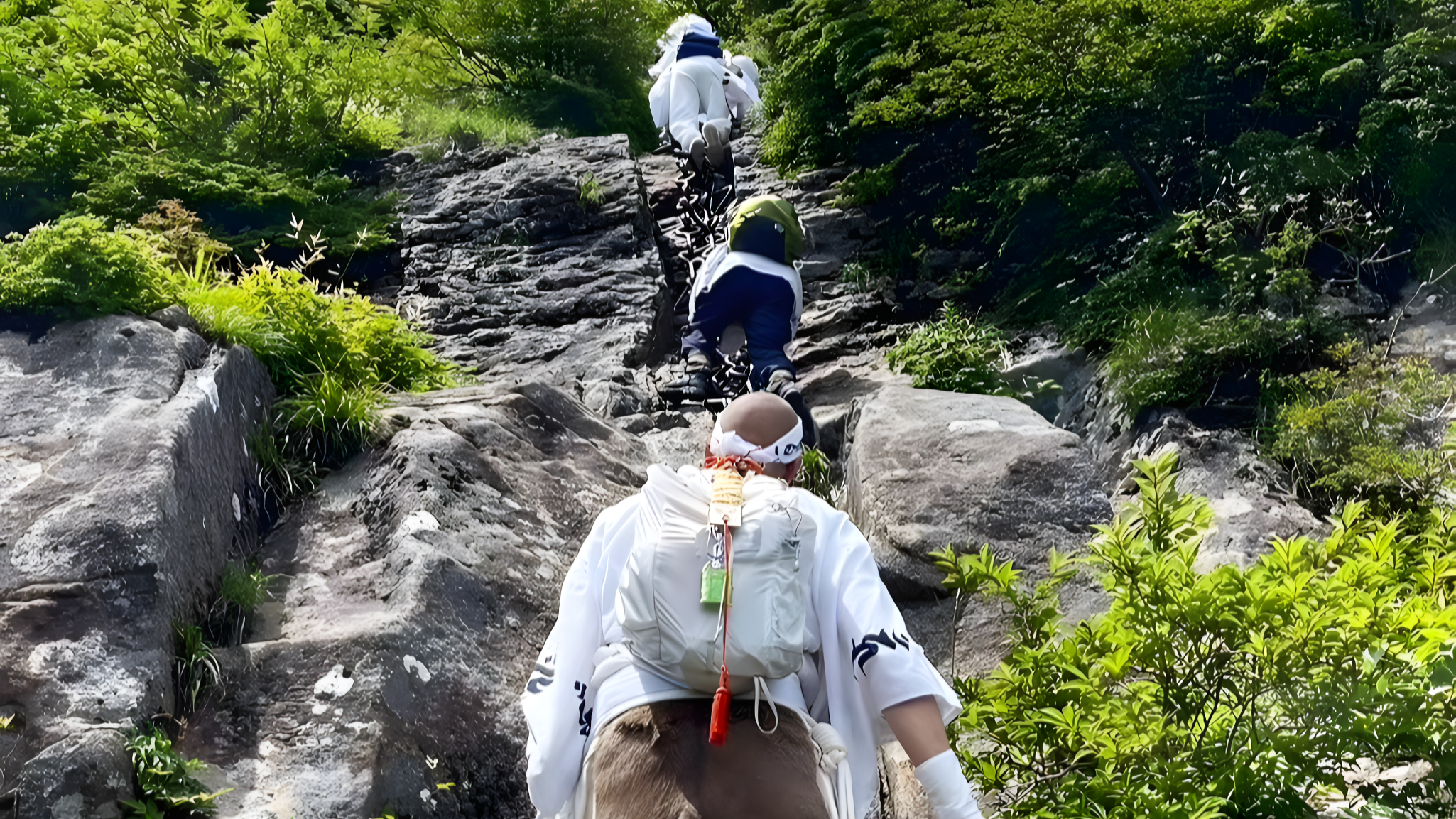 A Shugendo practitioner prepares to climb the third and final set of chains on Mt. Ishizuchi