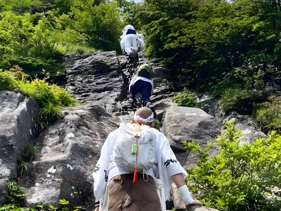 A Shugendo practitioner prepares to climb the third and final set of chains on Mt. Ishizuchi