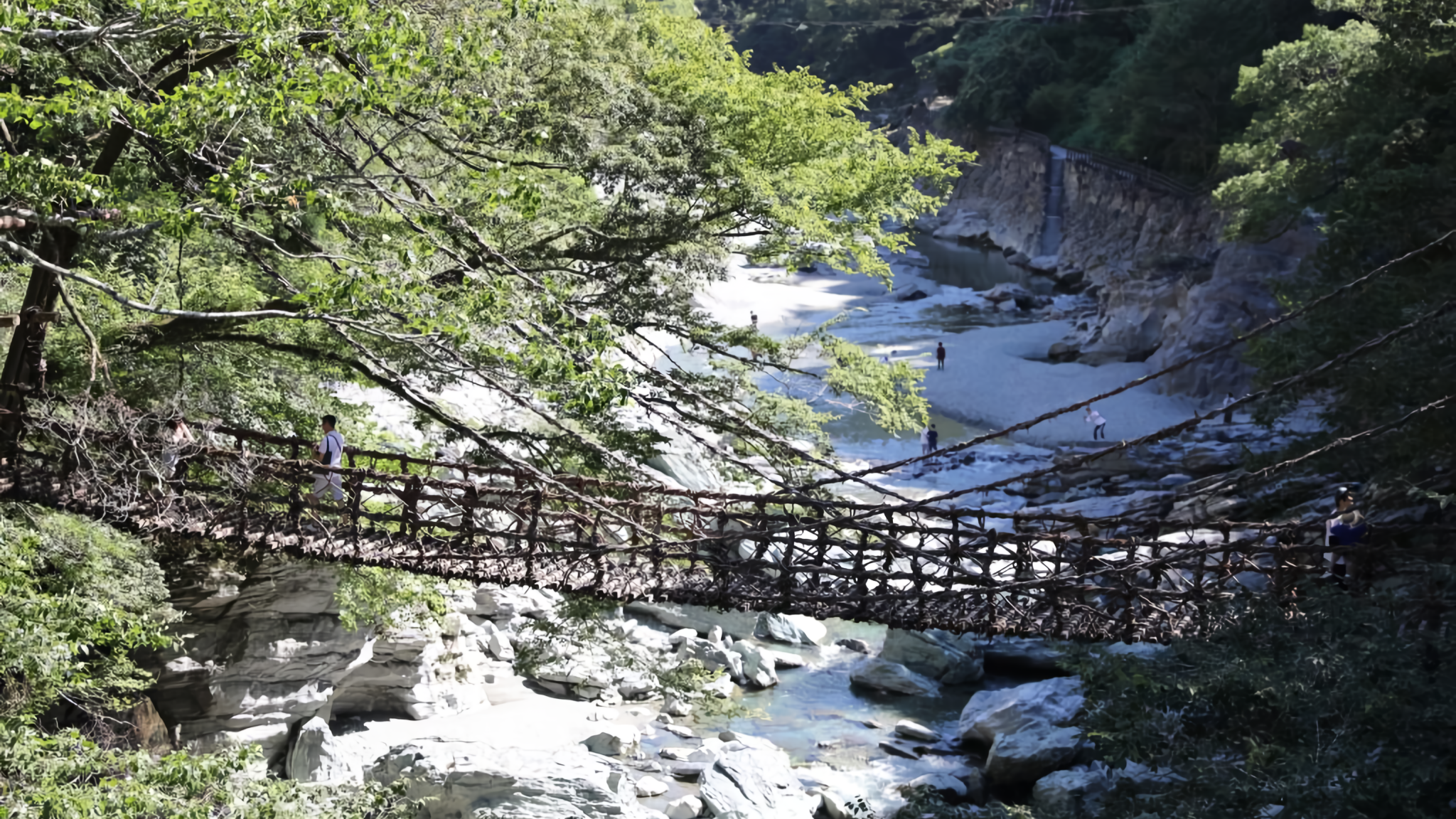 The Oku-Iya Kazurabashi Bridges are a pair of historic suspension bridges made of mountain vines, hidden deep within the scenic valley of Tokushi.