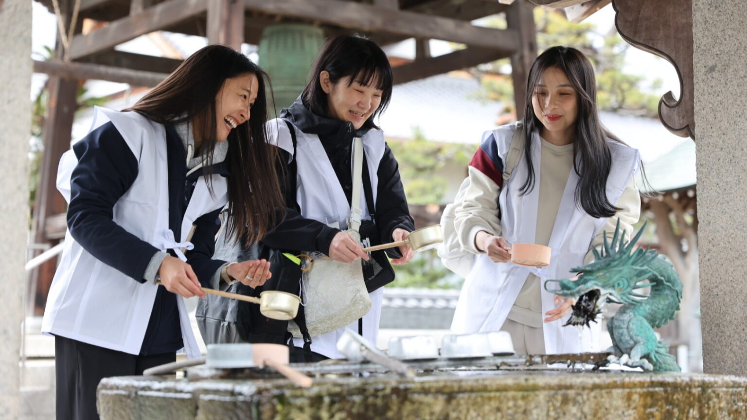 Pilgrims wash their hands at a temizuya in a Buddhist temple. Temizuya are common to both Shinto and Buddhism.