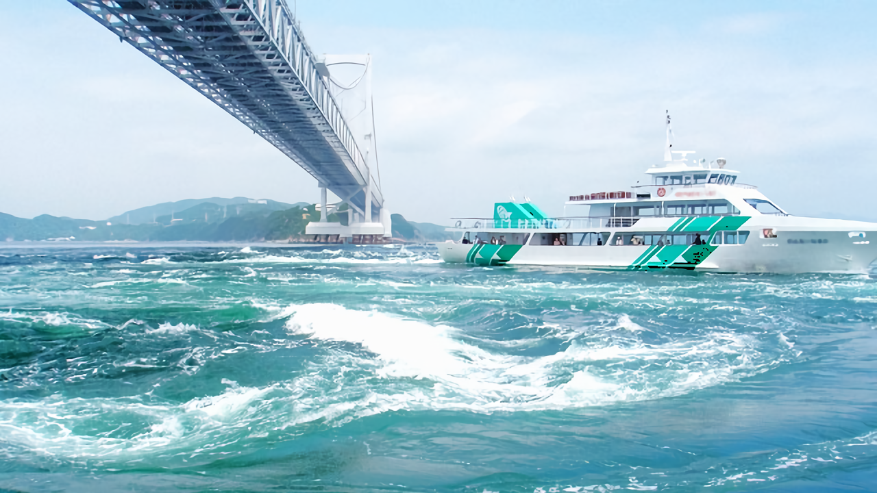 A sightseeing cruise boat navigating through the Naruto whirlpools beneath the Great Naruto Bridge in Tokushima, Japan.