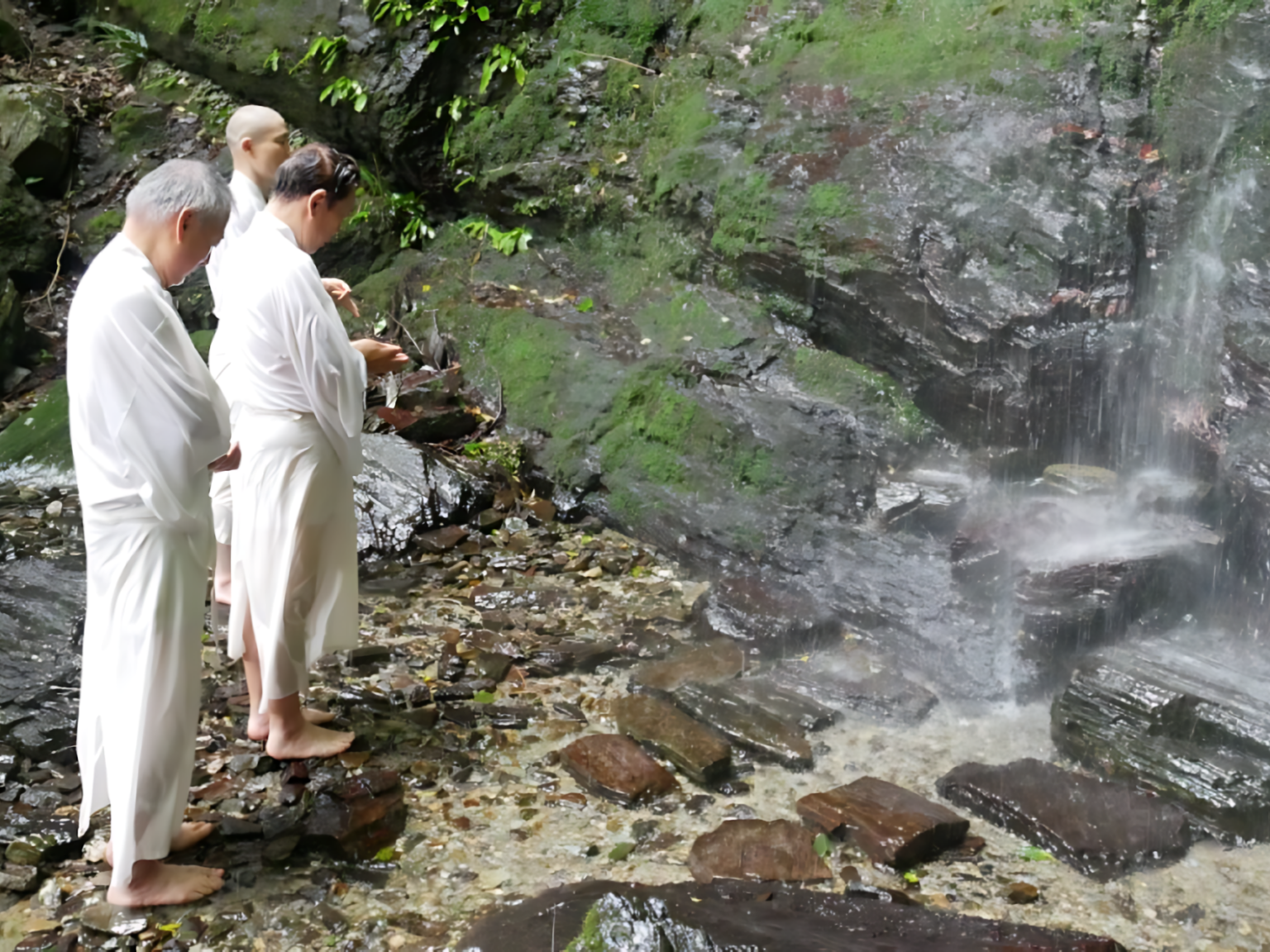 Practitioners prepare to meditate under the Konji Falls