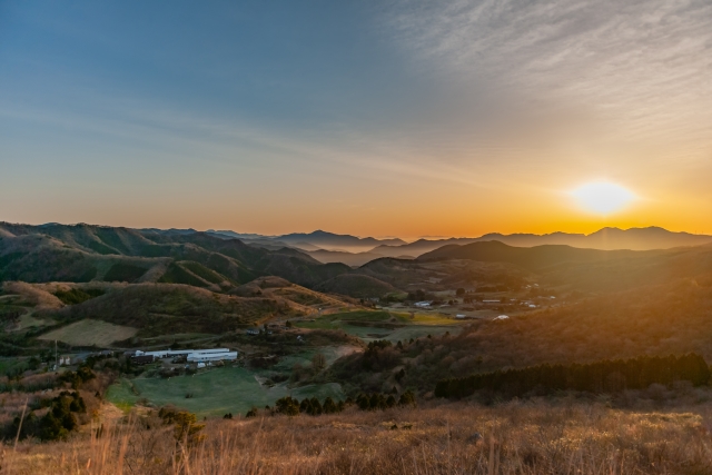 A beautiful sunrise over the rolling hills and pastures of Onogahara in Seiyo City.