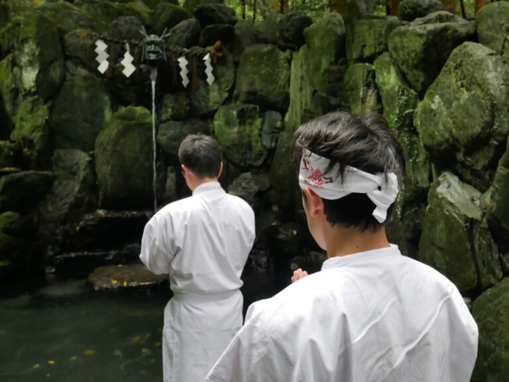 Practitioners prepare for misogi at Ishizuchi Shrine’s sacred falls.