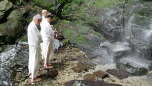Practitioners prepare to meditate under the Konji Falls