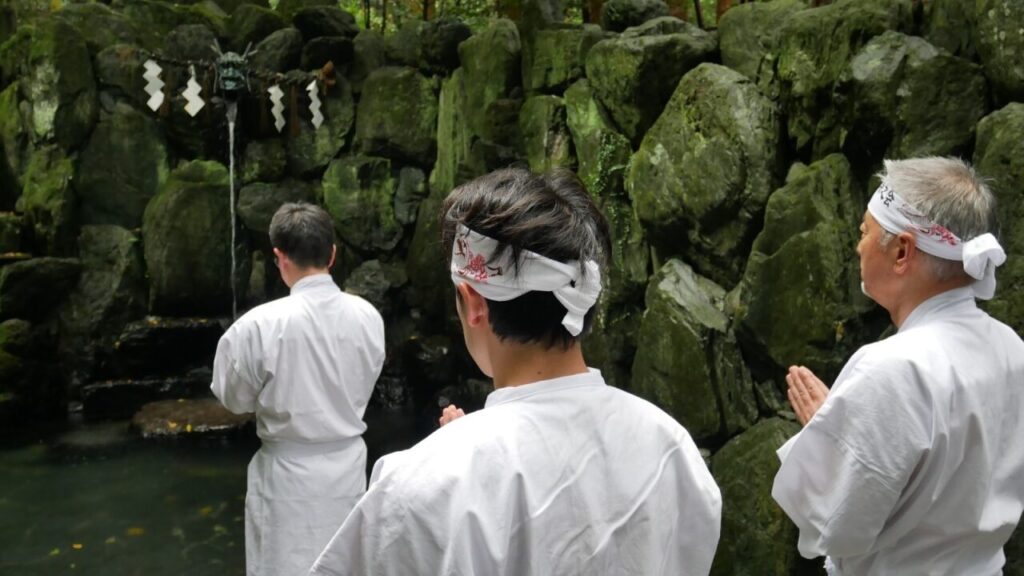 Practitioners prepare for misogi at Ishizuchi Shrine’s sacred falls.