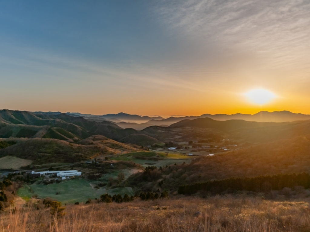 A beautiful sunrise over the rolling hills and pastures of Onogahara in Seiyo City.