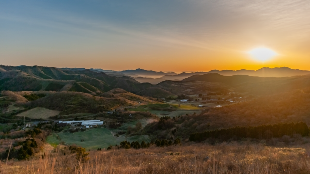 A beautiful sunrise over the rolling hills and pastures of Onogahara in Seiyo City.