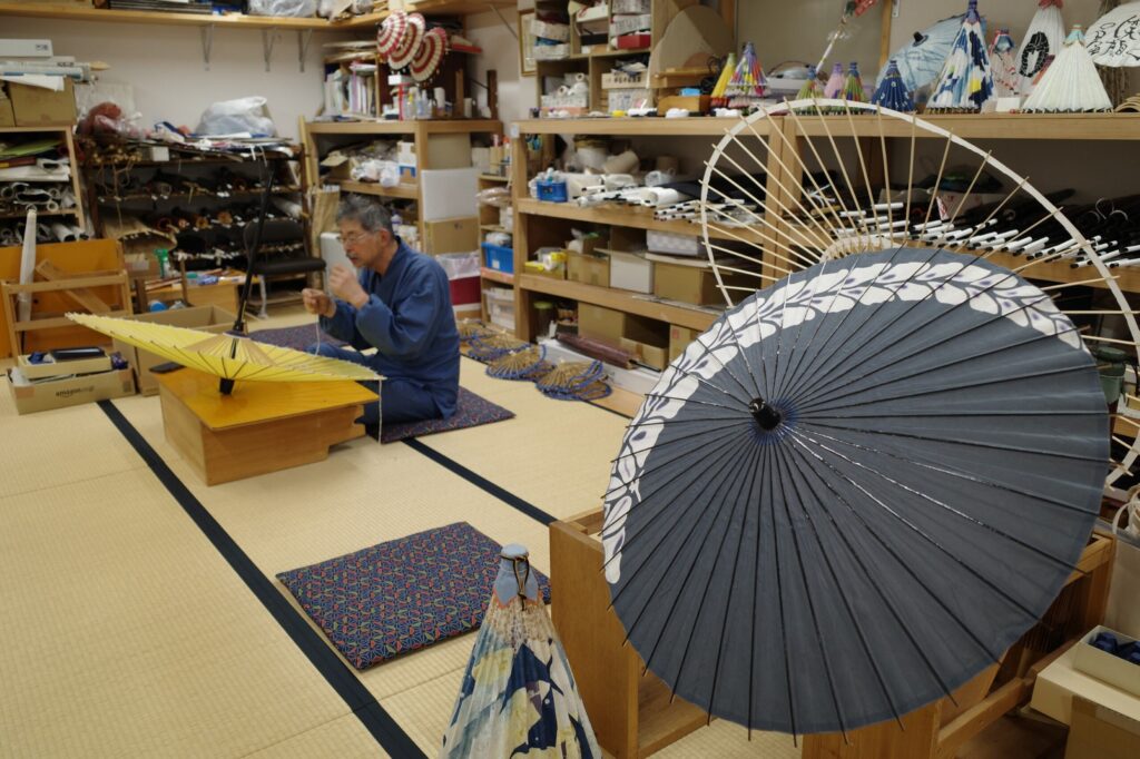 A craftsman at work in a traditional umbrella workshop