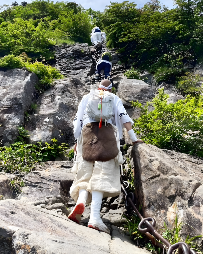 A Shugendo Practitioner stands at the bottom of the last of three chain sections on Mt. Ishizuchi. 