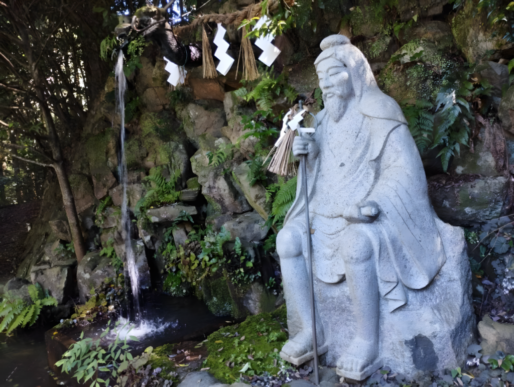 A statue of En no Gyoja at Ishizuchi Shrine in Saijo City, wearing his characteristic cowl and toothed geta sandals.