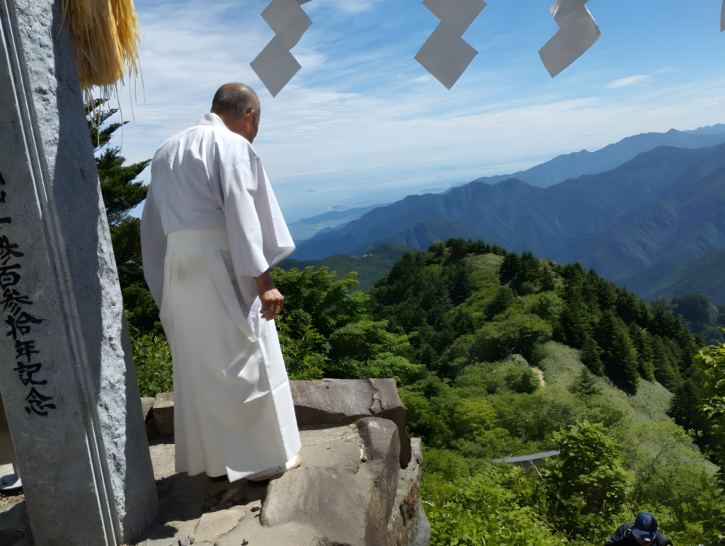 A Shinto priest looks out toward the Seto Inland Sea from one of the shrine’s several sacred gates. 