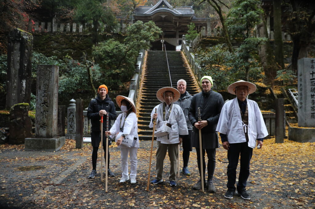 Hikers stand alongside pilgrims at Temple 44, Daiho-ji