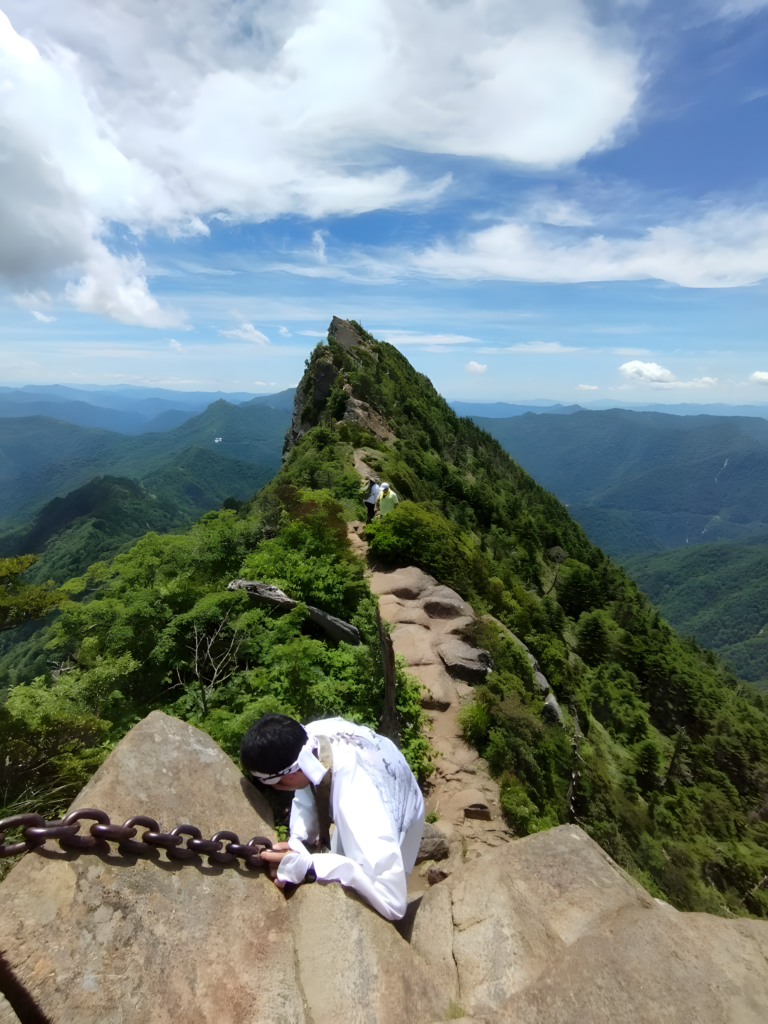 A Shugendo practitioner starts his final traverse toward the peak of Mt. Ishizuchi.