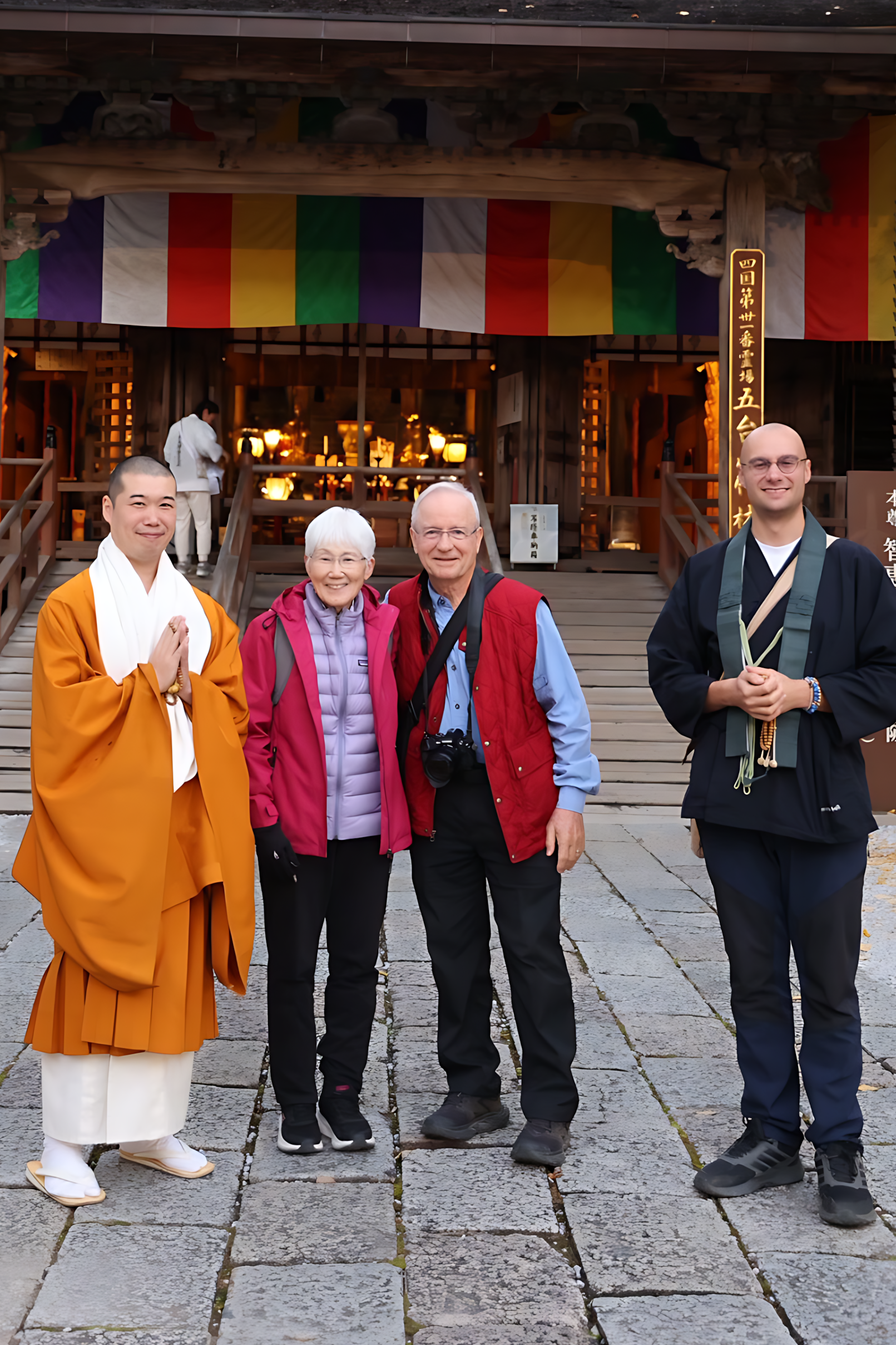 Visitors to Chikurin-ji smile alongside temple priests.
