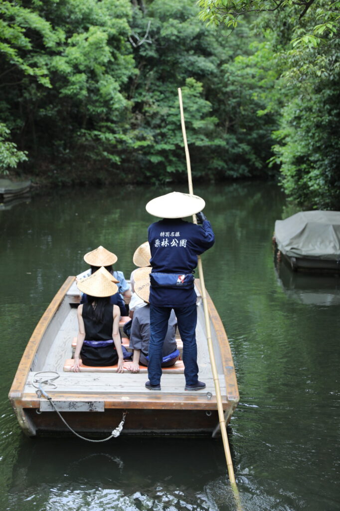 Visitors enjoy a cool boat ride at Takamatsu's Ritsurin Garden