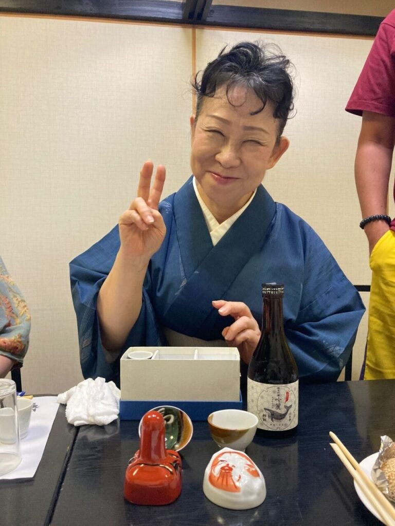 Ms. Nakano, proprietor of Junya, a Kochi eatery, demonstrates local drinking games.