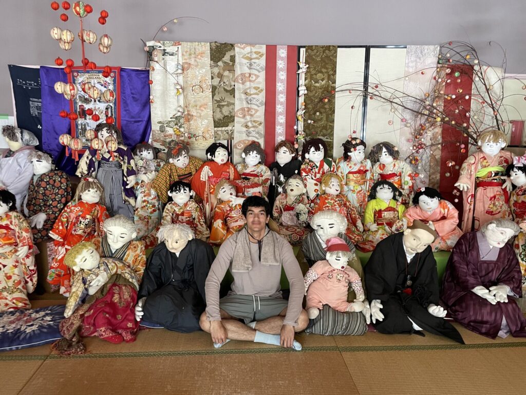 A visitor surrounded by scarecrows in Nagoro village, Tokushima