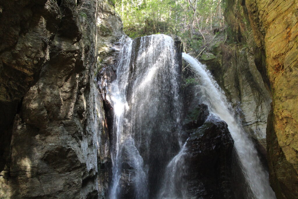 A waterfall cascades in many streams down the walls of the Nakatsu Gorge.
