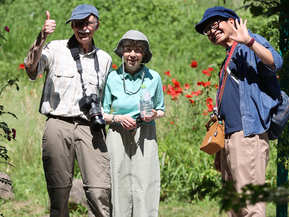 Guests and guide among summer flowers at Monet's Garden in Kitagawa Village, Kochi