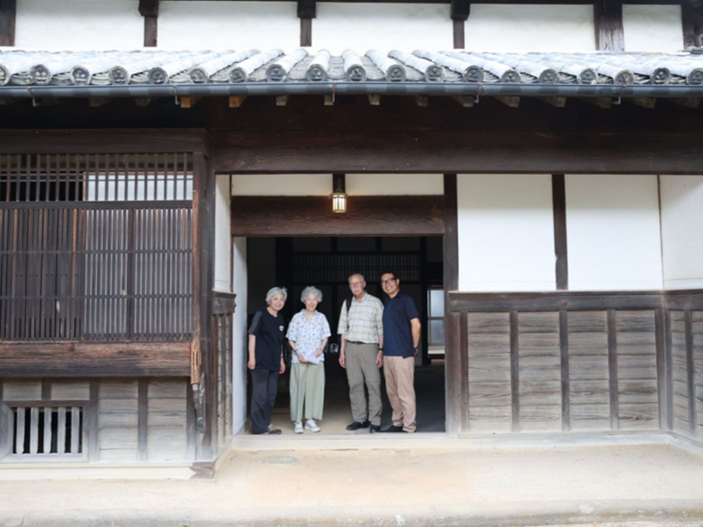 Guests and local guides at the entrance of the Watanabe Family House, a historic residence in Tobe Town, Ehime