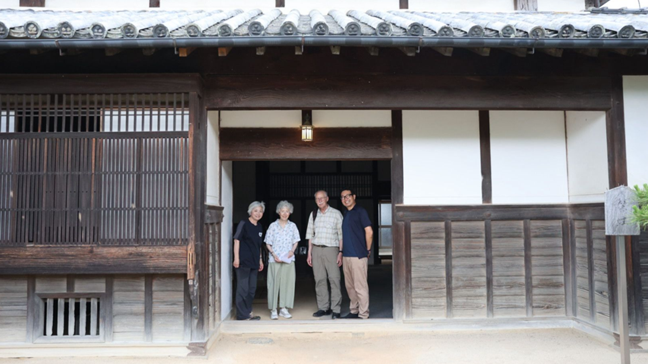 Guests and local guides at the entrance of the Watanabe Family House, a historic residence in Tobe Town, Ehime