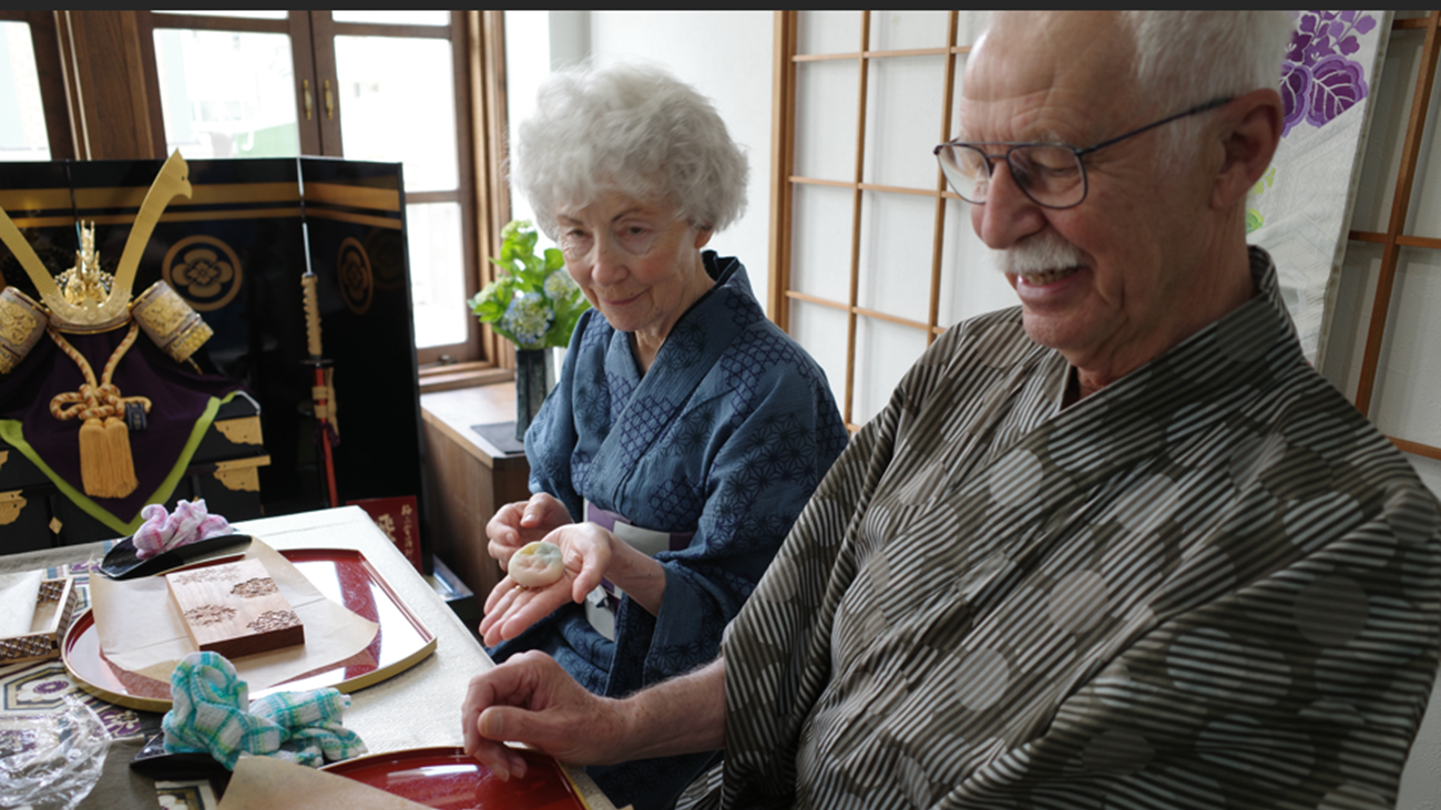 Couple in yukata shaping traditional Japanese wagashi sweets during a hands-on workshop