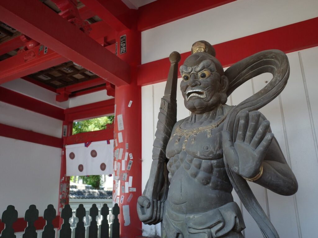 A guardian deity holding a club scares off malevolent forces at the gate of Konsen-ji. 