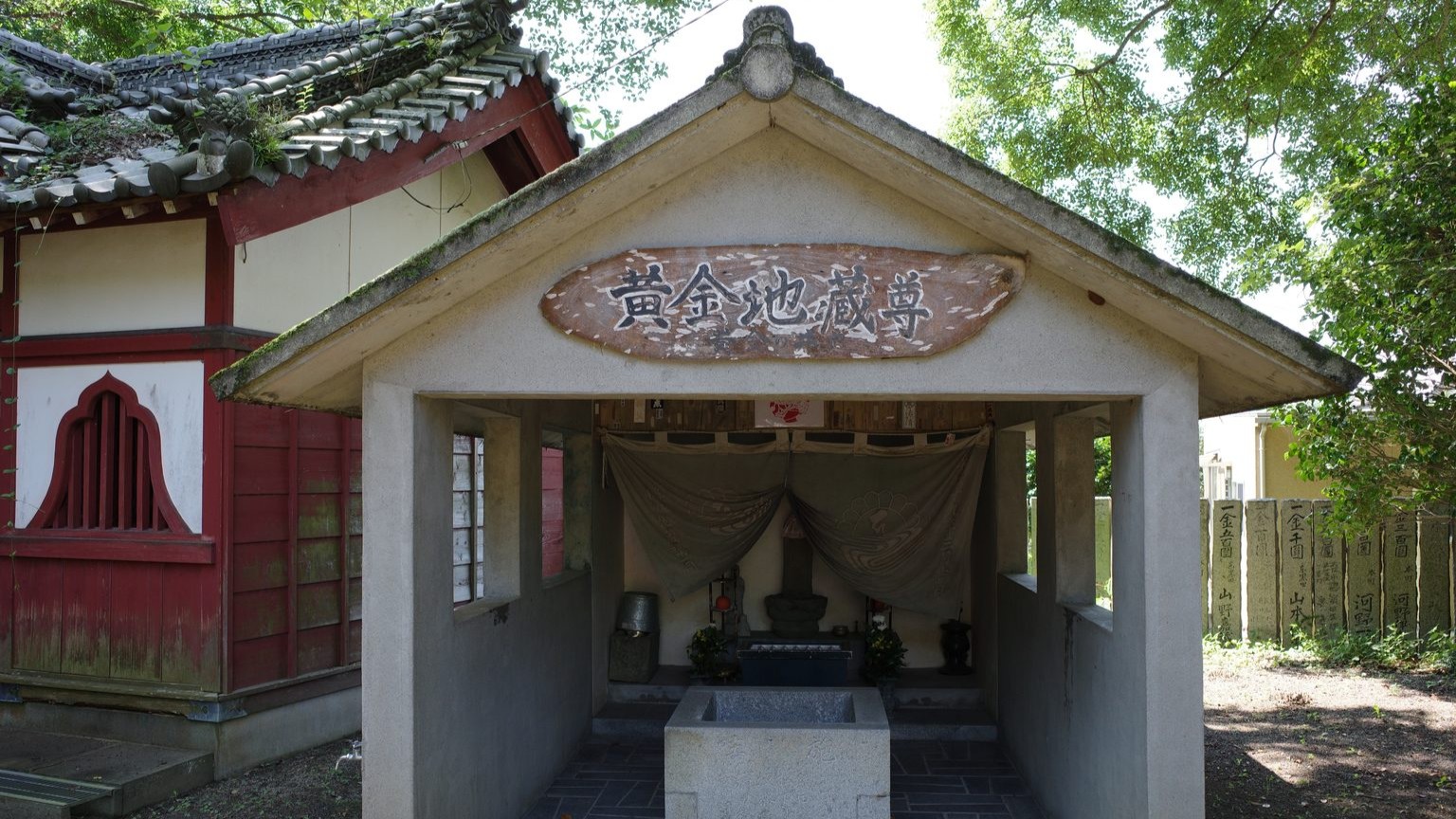A concrete shrine covers the miraculous well that gives Konsen-ji, "the Temple of the Golden Spring" its name. 