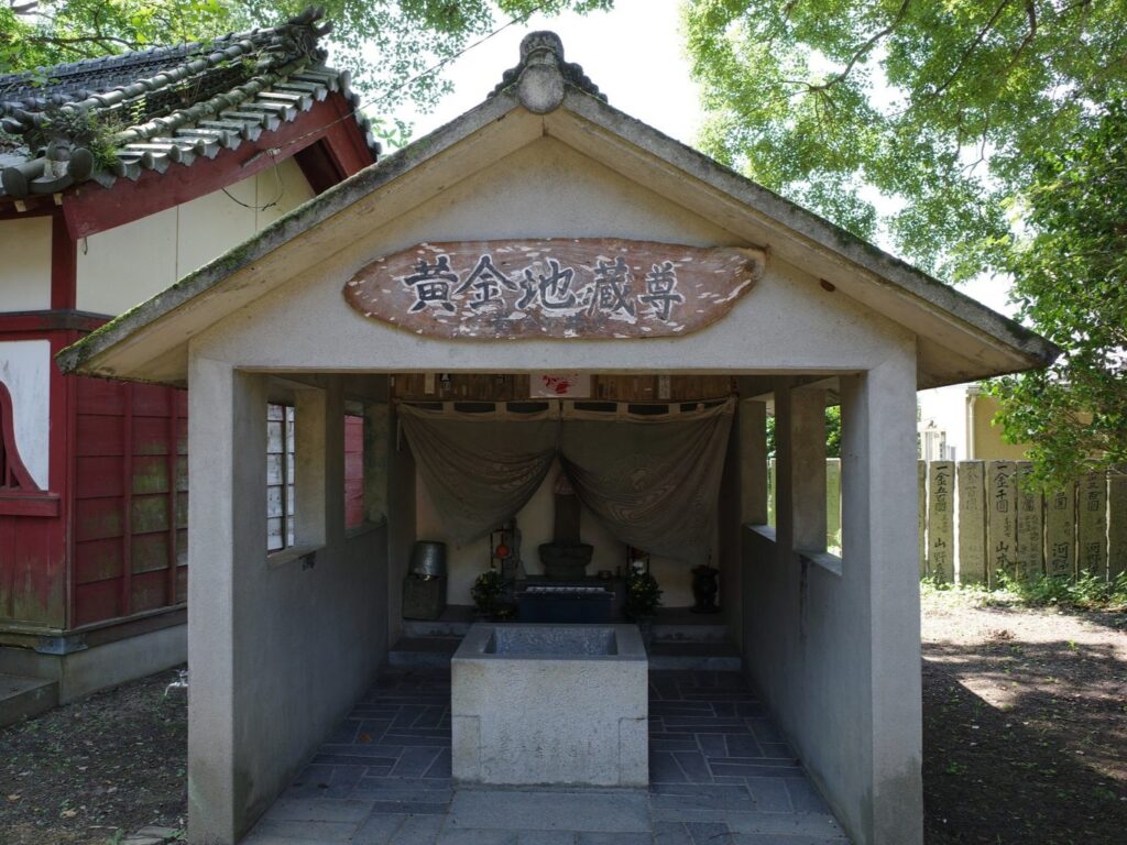 A concrete shrine covers the miraculous well that gives Konsen-ji, "the Temple of the Golden Spring" its name. 