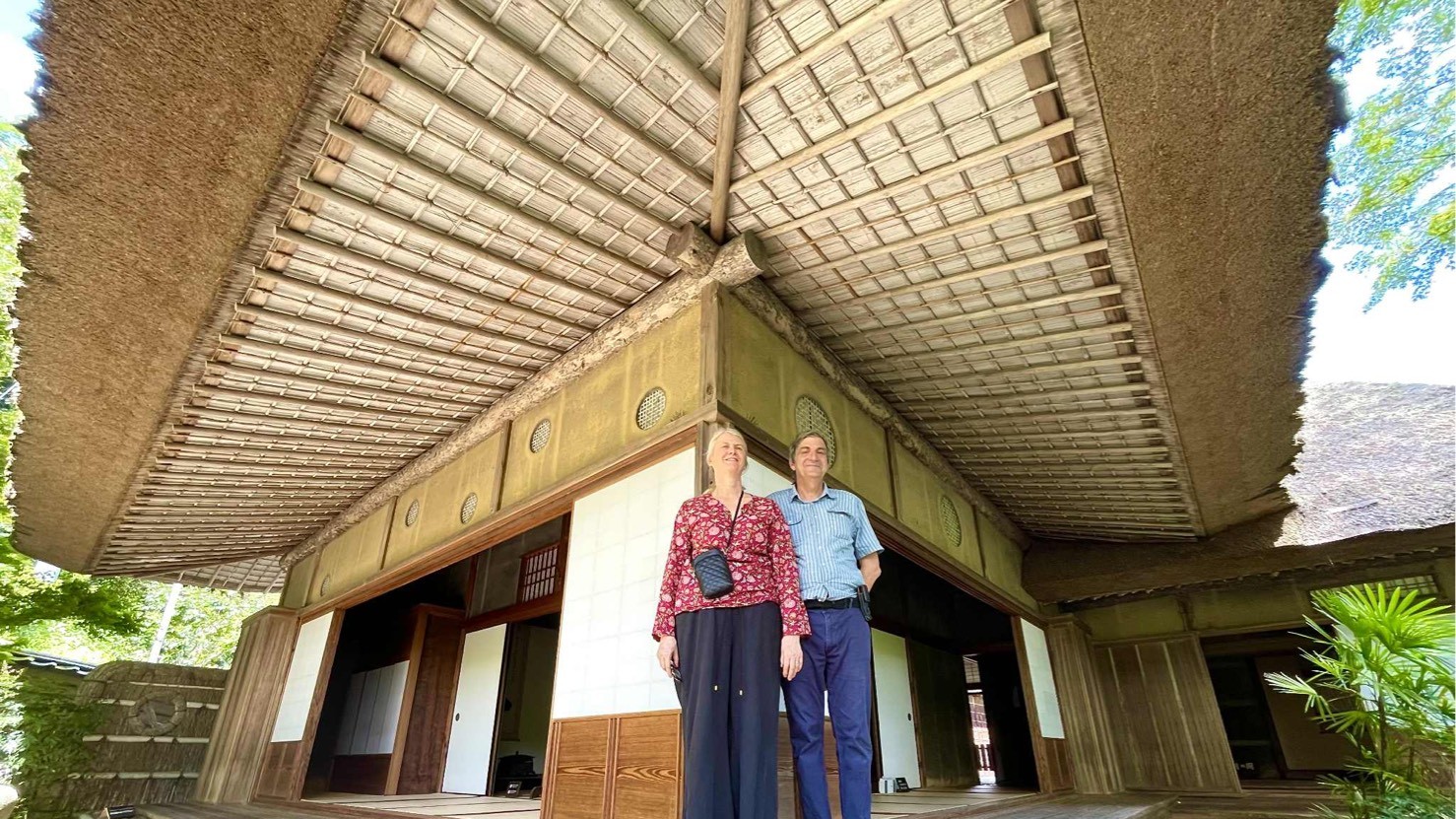 Two guests beneath the deep thatched eaves of Garyu Sanso, a Meiji-era villa in Ozu, Ehime