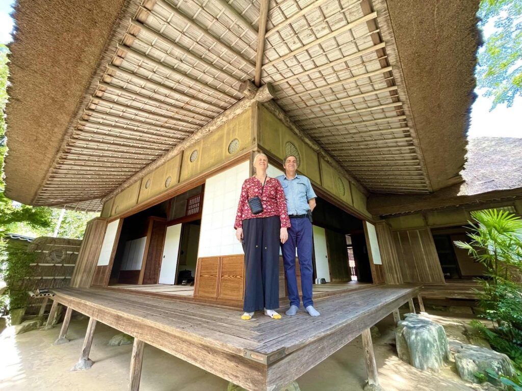 Two guests beneath the deep thatched eaves of Garyu Sanso, a Meiji-era villa in Ozu, Ehime