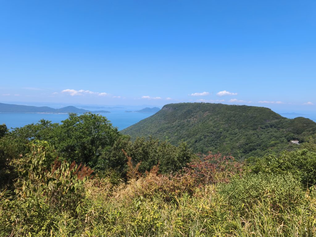 The green slopes of Yashima's northern peak stand stark against sapphire blue seas and skies.