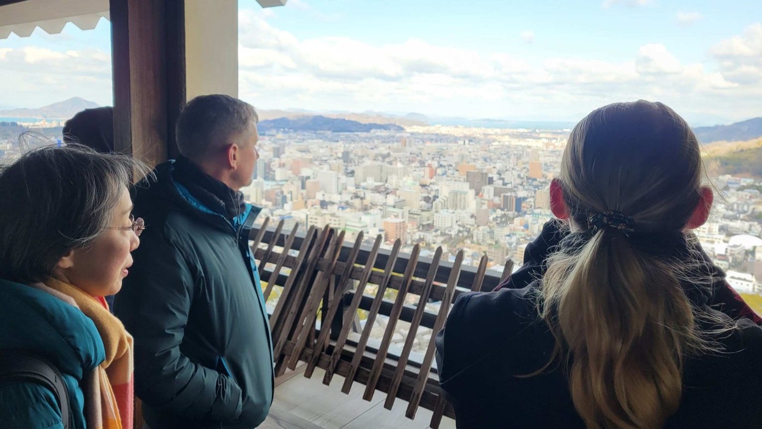Visitors look down from the top of the Tenshū tower. The fortress has watched Matsuyama transform from a medieval castle town to a vibrant, modern city.