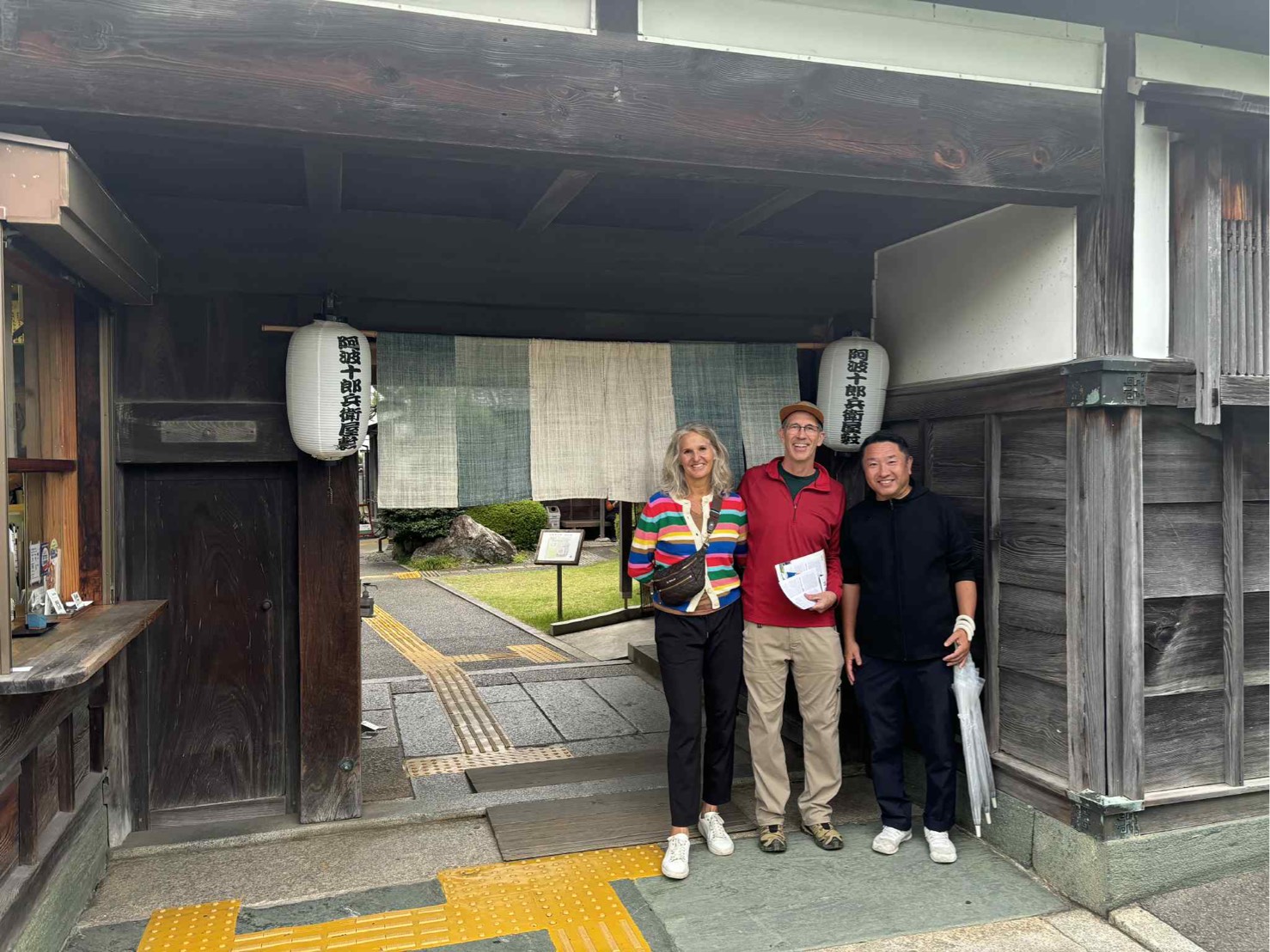Christine and her husband with their Shikoku Tours guide at the entrance gate of Awa Jurobei Yashiki, Tokushima